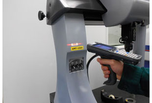 An employee of Arundel Machine Tool scanning a gage