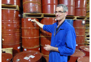 An employee of Cammell's scanning barrels of Honey